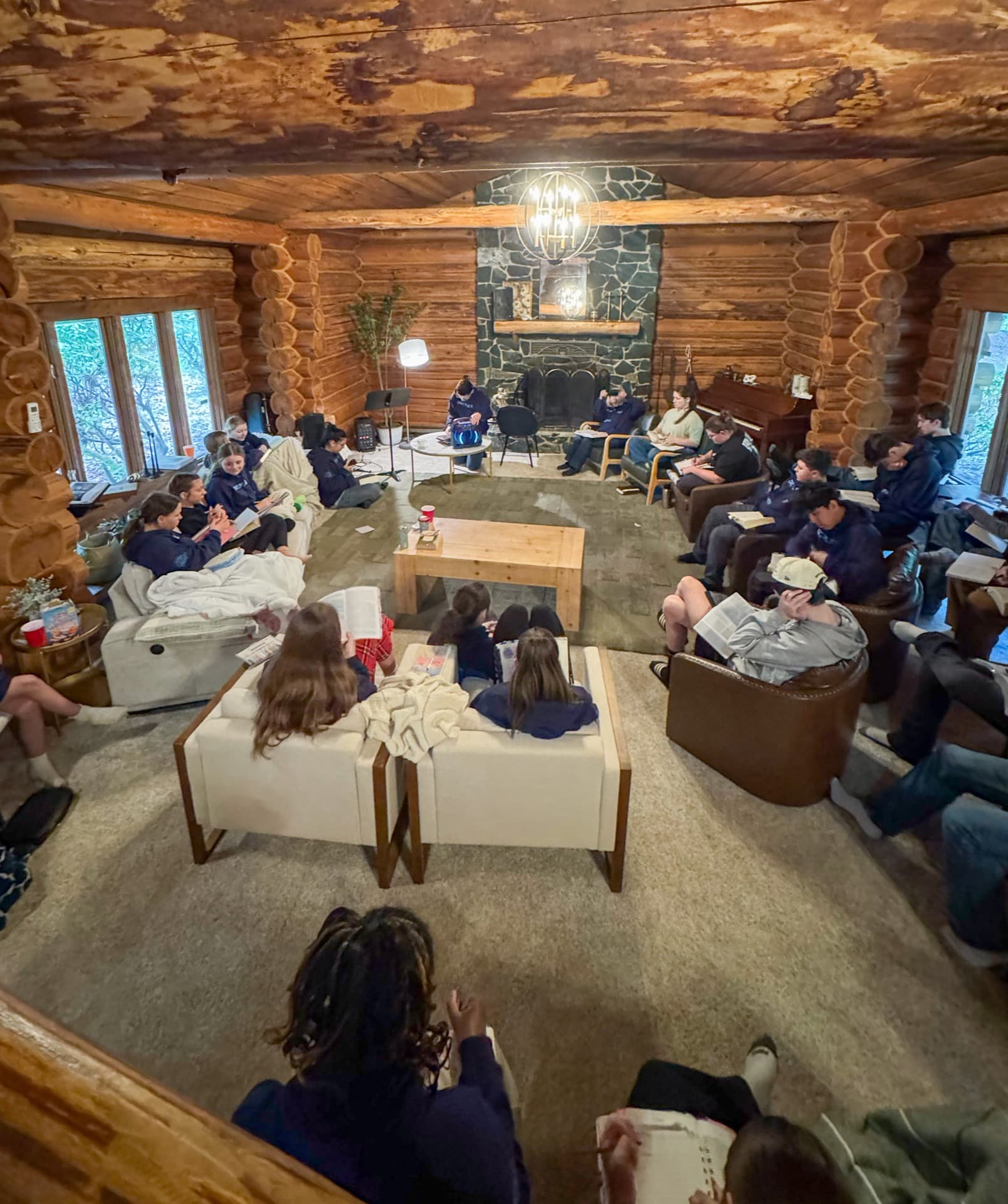 Great room with stone fireplace and full group gathering